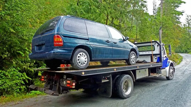 Regina flatbed towing a cargo van
