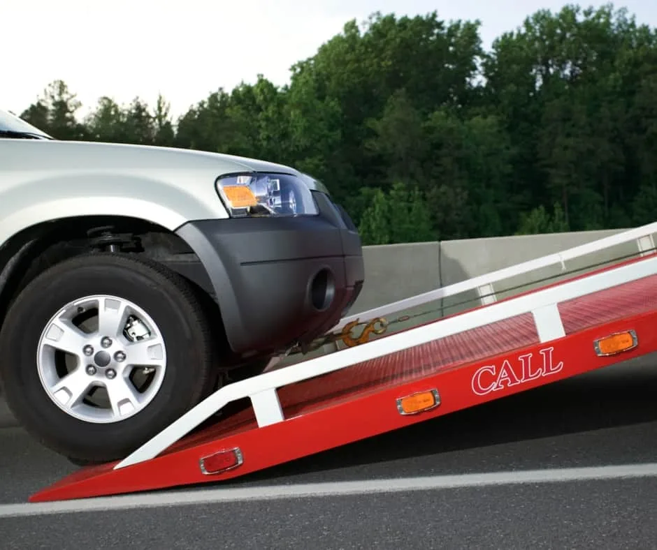 Regina tow truck loading a vehicle on a residential street