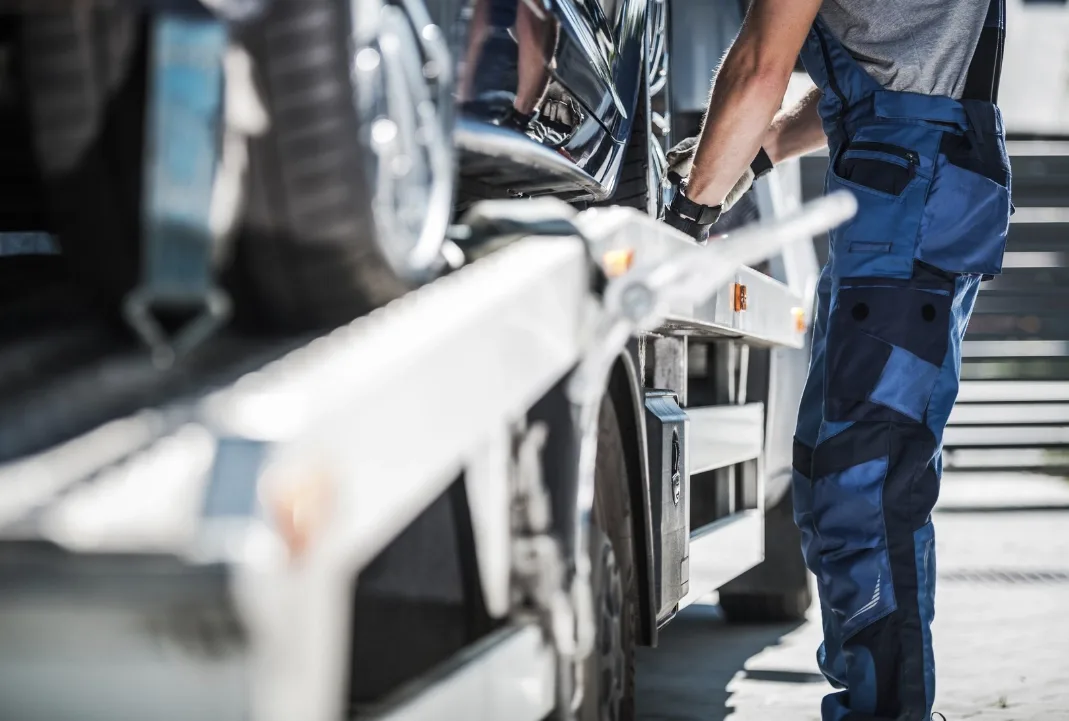 Regina tow truck driver loading a car onto a flatbed