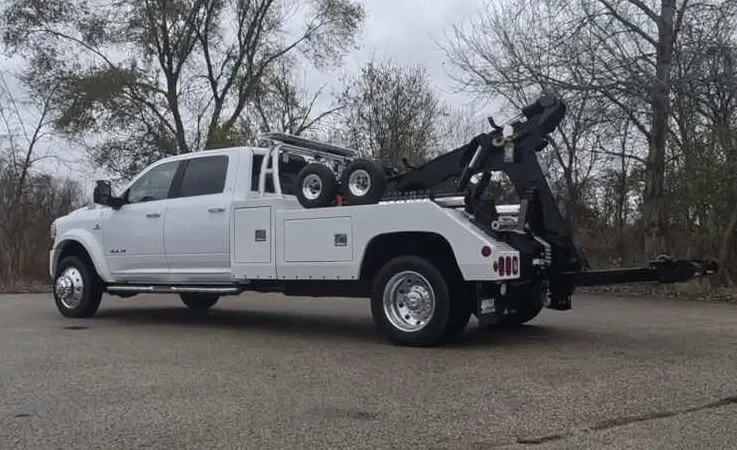 Regina wrecker equipment securing damaged vehicle